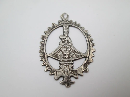 Virgin of the Head silver openwork medal. Crescent ornament and triangular edge