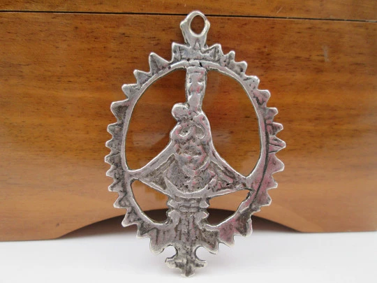 Virgin of the Head silver openwork medal. Crescent ornament and triangular edge