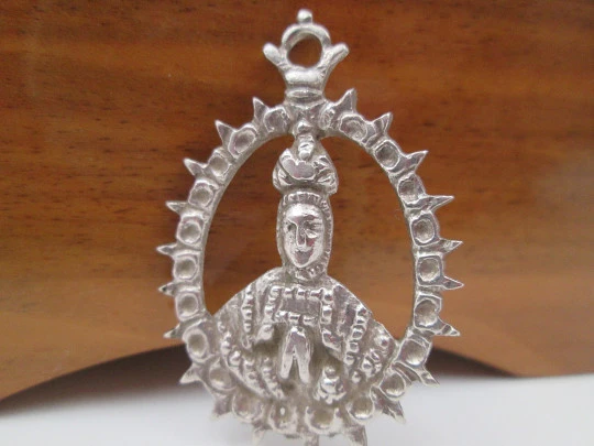 Virgin of the Tabernacle silver openwork medal. Sphere decorations and triangular edge. 1900's