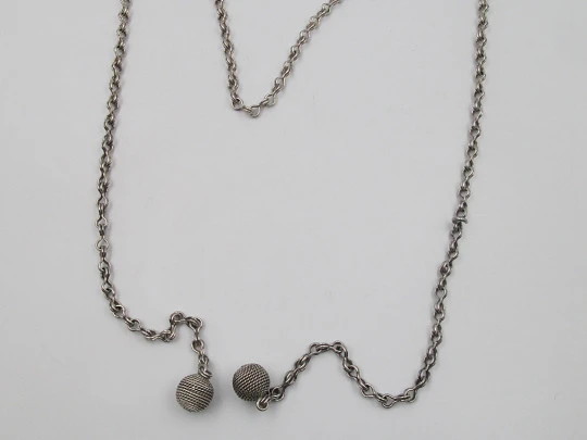 Woman necklace. Chain with links on eight. Ball ends with cord motif. 1950's. Europe