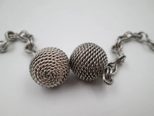 Woman necklace. Chain with links on eight. Ball ends with cord motif. 1950's. Europe