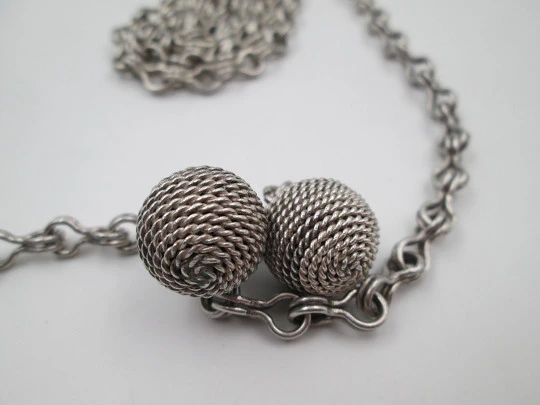 Woman necklace. Chain with links on eight. Ball ends with cord motif. 1950's. Europe