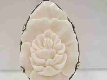 Woman's pendant. Bone and sterling silver. 1950's. Flower motif. Relief