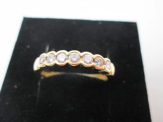 Women's alliance ring. 18 karat gold and seven diamonds. Circa 2005