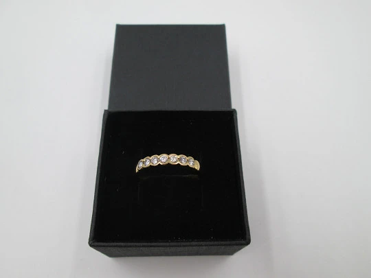 Women's alliance ring. 18 karat gold and seven diamonds. Circa 2005