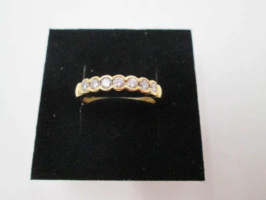 Women's alliance ring. 18 karat gold and seven diamonds. Circa 2005