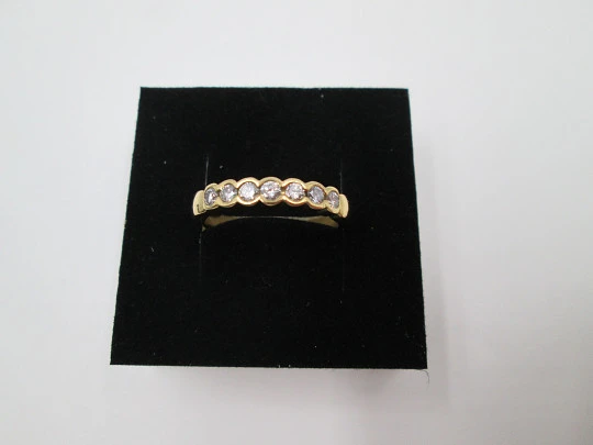 Women's alliance ring. 18 karat gold and seven diamonds. Circa 2005