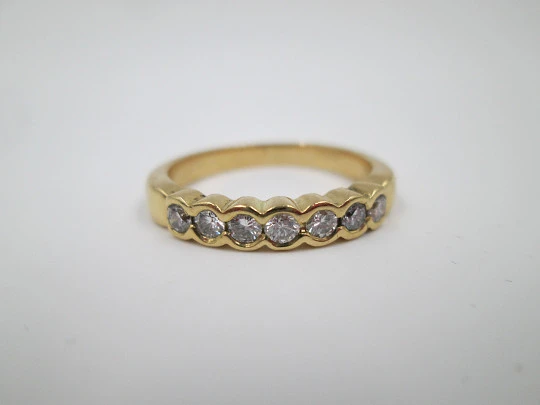 Women's alliance ring. 18 karat gold and seven diamonds. Circa 2005