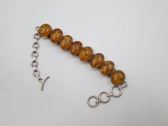 Women's articulated bracelet. Sterling silver & amber. Toggle clasp. 1980's