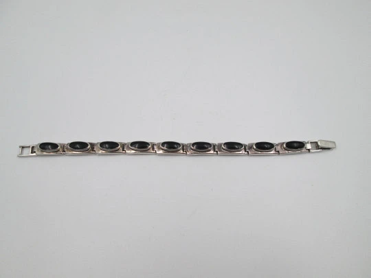Women's articulated bracelet. Sterling silver and black stones. Tab clasp. 1990's. Europe