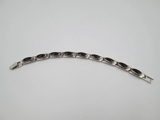 Women's articulated bracelet. Sterling silver and black stones. Tab clasp. 1990's. Europe