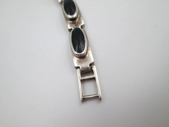 Women's articulated bracelet. Sterling silver and black stones. Tab clasp. 1990's. Europe