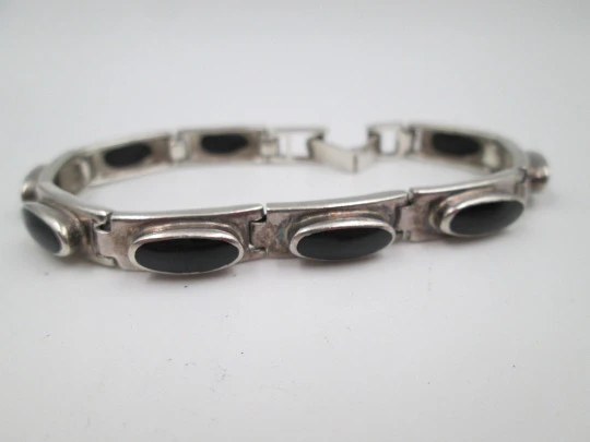 Women's articulated bracelet. Sterling silver and black stones. Tab clasp. 1990's. Europe
