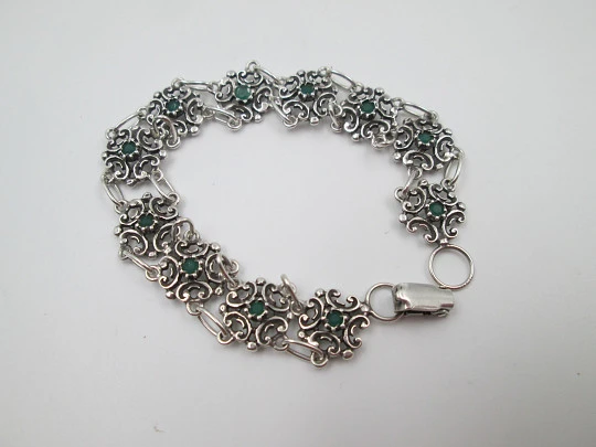 Women's bracelet. Sterling silver. Green stones and arabesque motifs. Tab clasp. 1990's