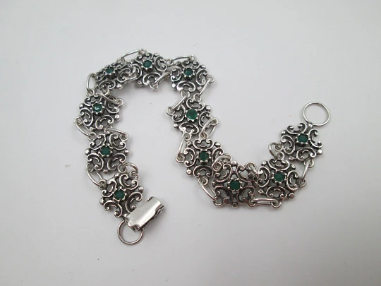 Women's bracelet. Sterling silver. Green stones and arabesque motifs. Tab clasp. 1990's