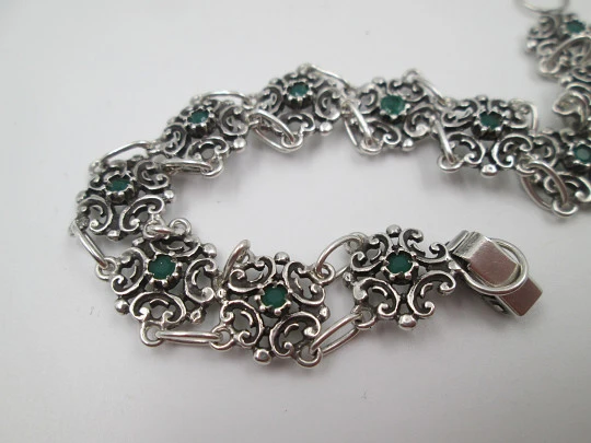 Women's bracelet. Sterling silver. Green stones and arabesque motifs. Tab clasp. 1990's
