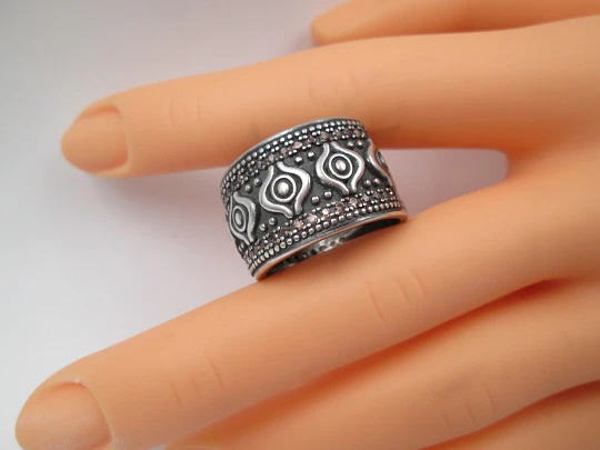 Women's broad ring. Sterling silver. Pink gems and tribal ornaments. Europe. 1990's Women's broad ring. Sterling silver. Pink gems and tribal ornaments. Europe. 1990's