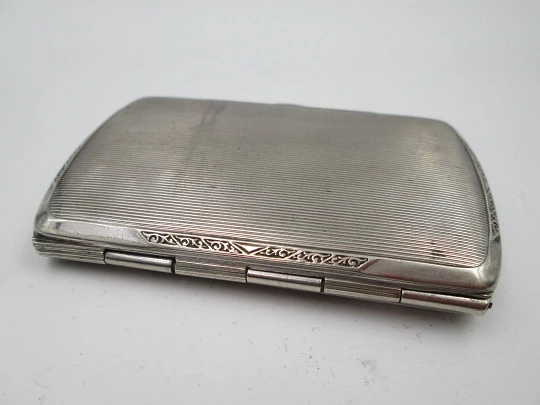 Women's cigarette case. Silver plated metal. Geometric and vegetable motifs. Europe