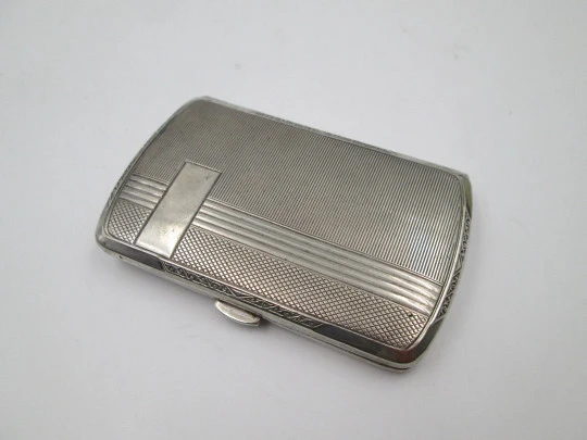 Women's cigarette case. Silver plated metal. Geometric and vegetable motifs. Europe