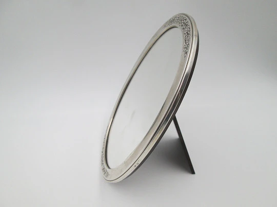 Women's dressing table mirror. Sterling silver and resin. Floral motifs. Spain. 1990's