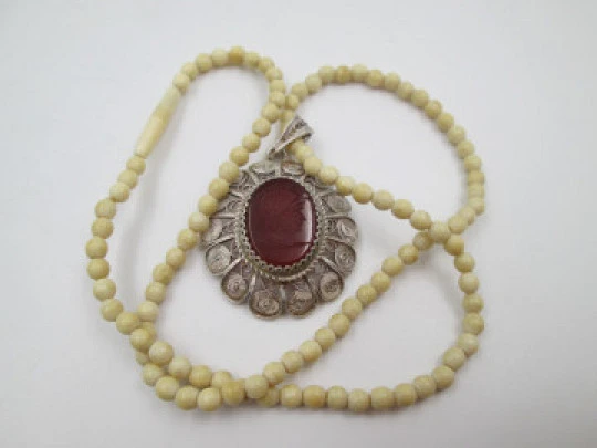 Women's ivory necklace with 900 sterling silver filigree pendant. Warrior cameo. 1940's