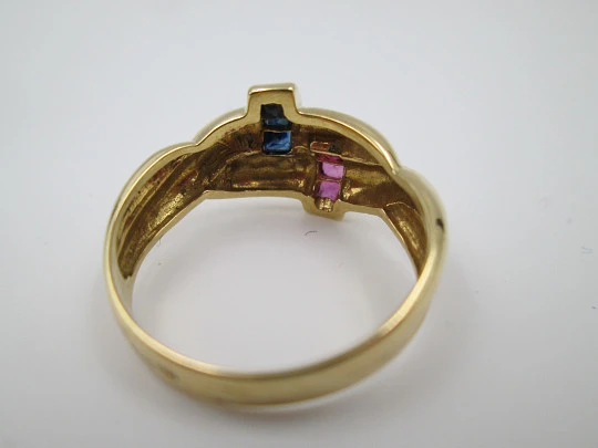 Women's loop ring. 18 karat yellow gold. Rubies and sapphires. 1980's. Europe