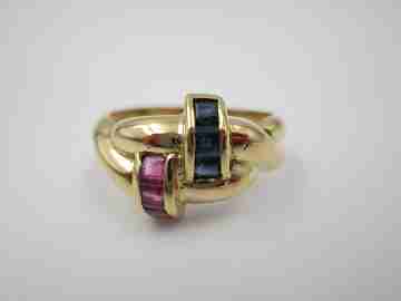 Women's loop ring. 18 karat yellow gold. Rubies and sapphires. 1980's. Europe