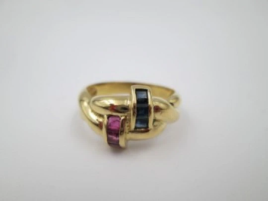 Women's loop ring. 18 karat yellow gold. Rubies and sapphires. 1980's. Europe