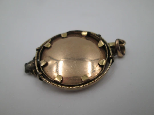 Women's low grade gold photo frame pendant. Floral motifs. Ring on top. 1930's