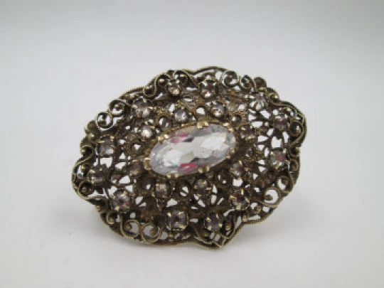 Women's openwork brooch. Gold plated metal and white rhinestones. Europe. 1950's