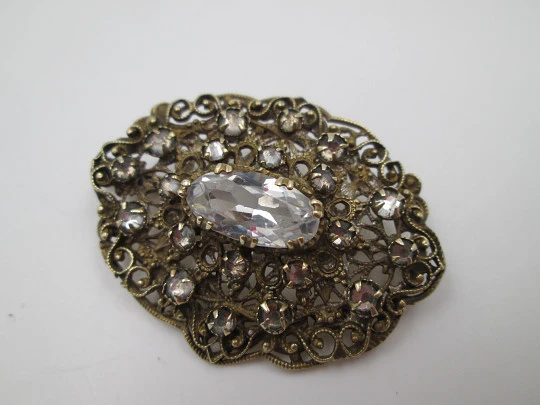 Women's openwork brooch. Gold plated metal and white rhinestones. Europe. 1950's