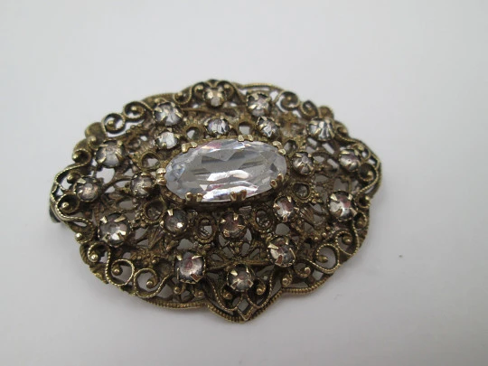 Women's openwork brooch. Gold plated metal and white rhinestones. Europe. 1950's