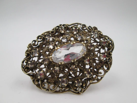 Women's openwork brooch. Gold plated metal and white rhinestones. Europe. 1950's