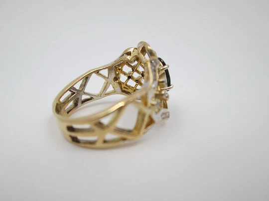 Women's openwork ring. 18 karat yellow gold, diamonds and sapphire. Europe