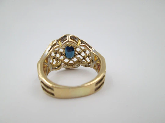 Women's openwork ring. 18 karat yellow gold, diamonds and sapphire. Europe