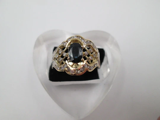 Women's openwork ring. 18 karat yellow gold, diamonds and sapphire. Europe