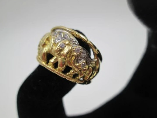 Women's ring. 18 karat gold & white sapphires. Elephants herd. 1990's