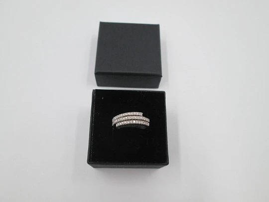 Women's ring. 18 karat white gold and three diamonds rows. Europe