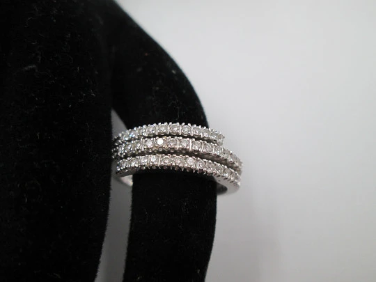 Women's ring. 18 karat white gold and three diamonds rows. Europe