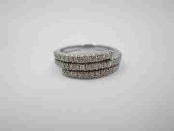 Women's ring. 18 karat white gold and three diamonds rows. Europe