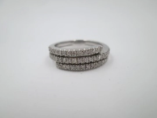 Women's ring. 18 karat white gold and three diamonds rows. Europe