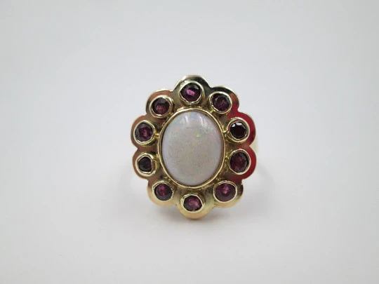 Women's ring. 18 karat yellow gold. Rubies and central opal. 1940's