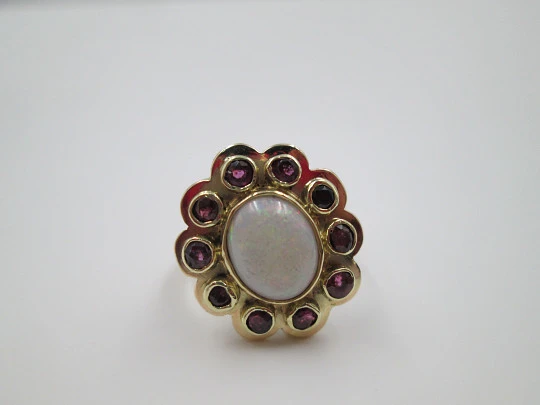 Women's ring. 18 karat yellow gold. Rubies and central opal. 1940's