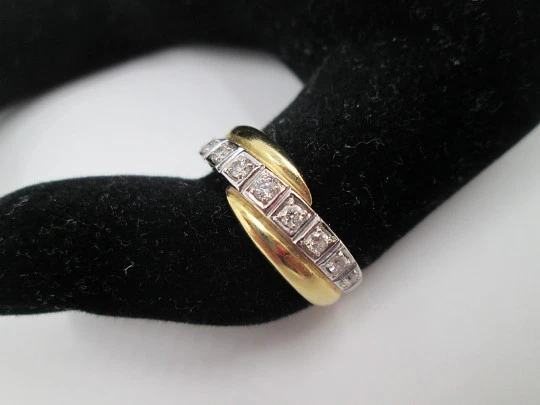 Women's ring. 18 karat yellow & white gold. Nine diamonds. Circa 2005