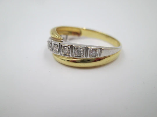 Women's ring. 18 karat yellow & white gold. Nine diamonds. Circa 2005