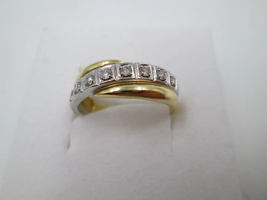 Women's ring. 18 karat yellow & white gold. Nine diamonds. Circa 2005