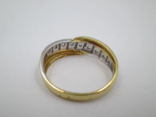 Women's ring. 18 karat yellow & white gold. Nine diamonds. Circa 2005