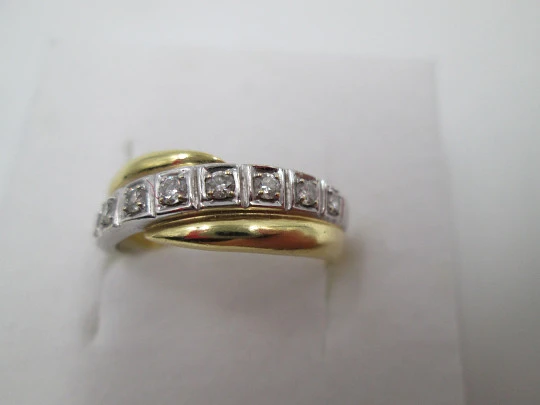 Women's ring. 18 karat yellow & white gold. Nine diamonds. Circa 2005