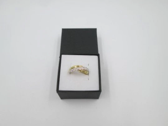 Women's ring. 18 karat yellow & white gold. Nine diamonds. Circa 2005