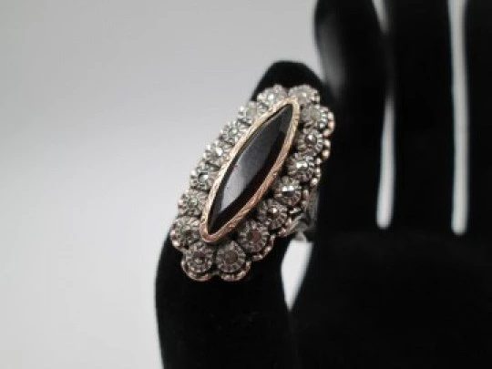 Women's shuttle ring. Silver and gold edge. Garnet stone & marcasite gems